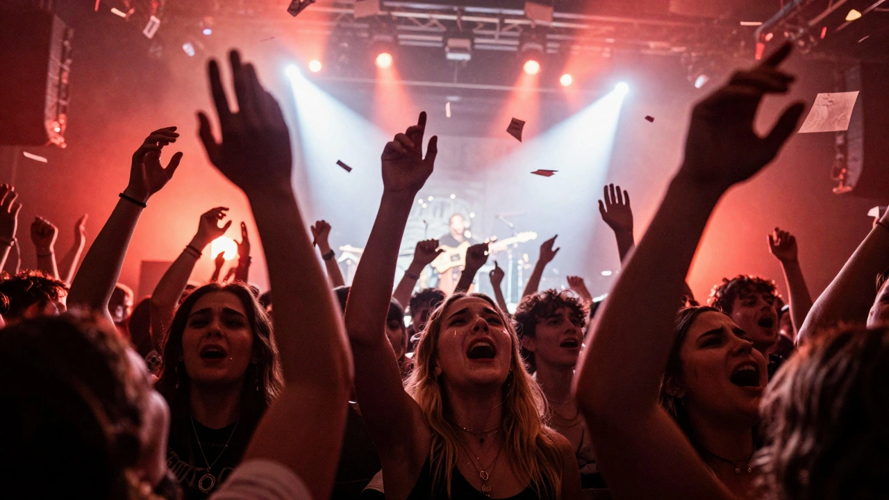 A crowd singing passionately under colorful lights, arms raised, as Alli Starr performs with her full band in an emotional crescendo.