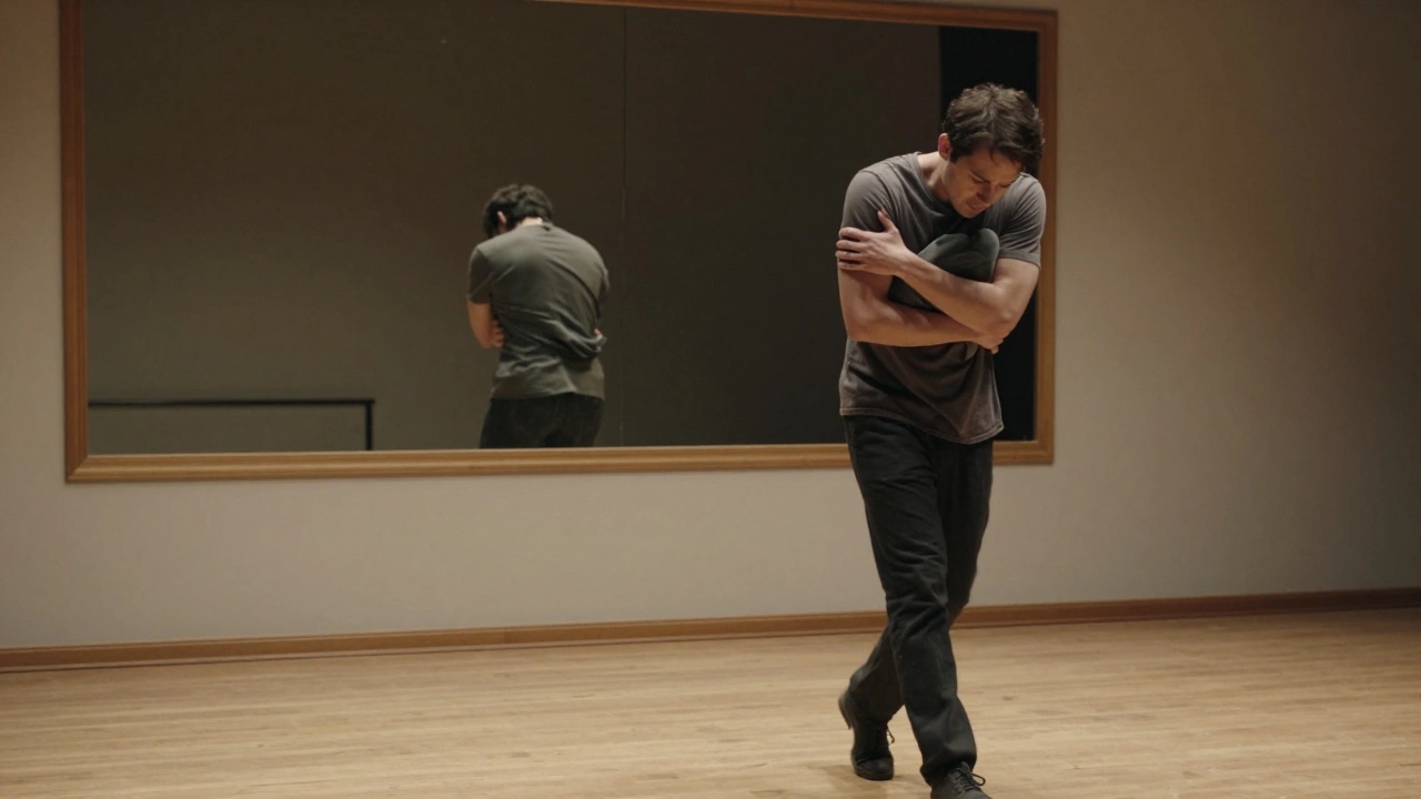 An actor walking with invisible weight across a stage, reflected in a mirror, showing emotional tension.